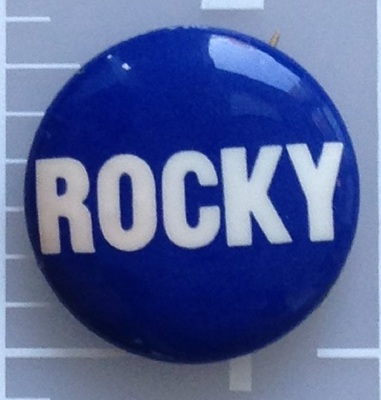 Rocky blue lithograph campaign button. Blue with white lettering